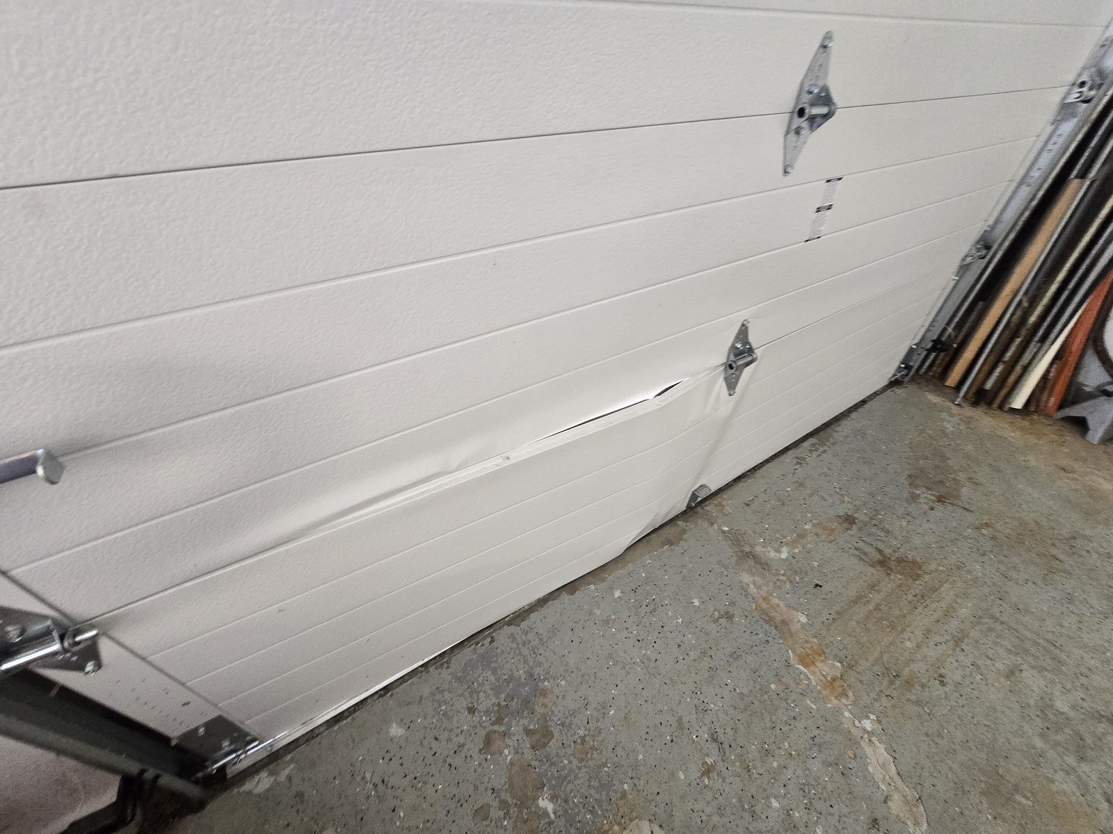 Damaged garage door before repair, photo 2