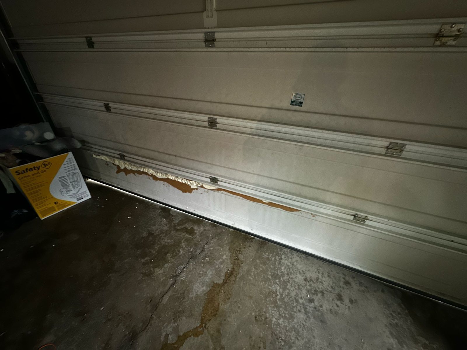 Damaged garage door before repair