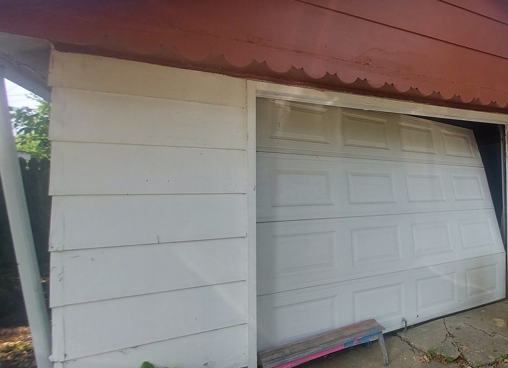 Damaged garage door before repair