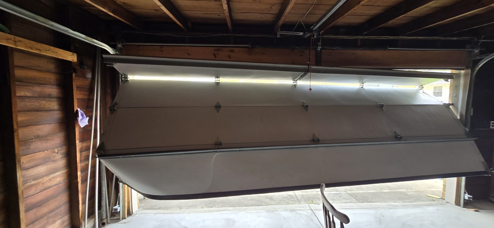 Damaged garage door before repair, photo 5