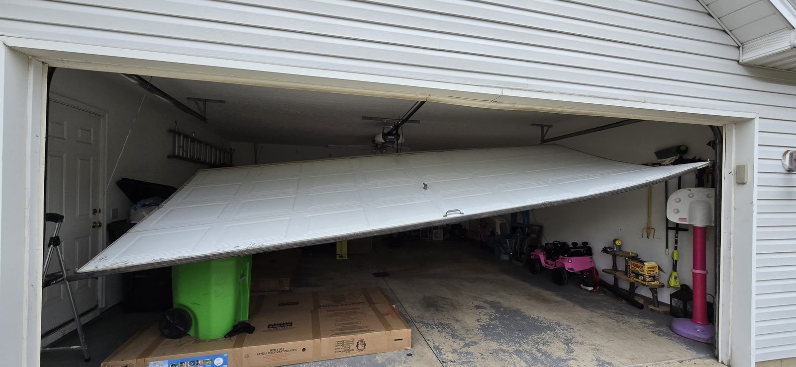 Damaged garage door before repair