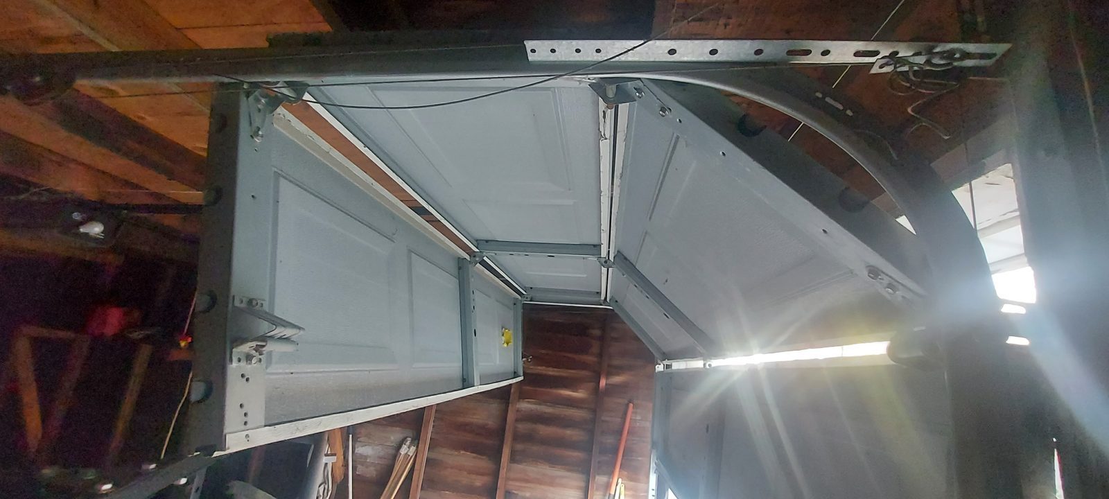 Damaged garage door before repair