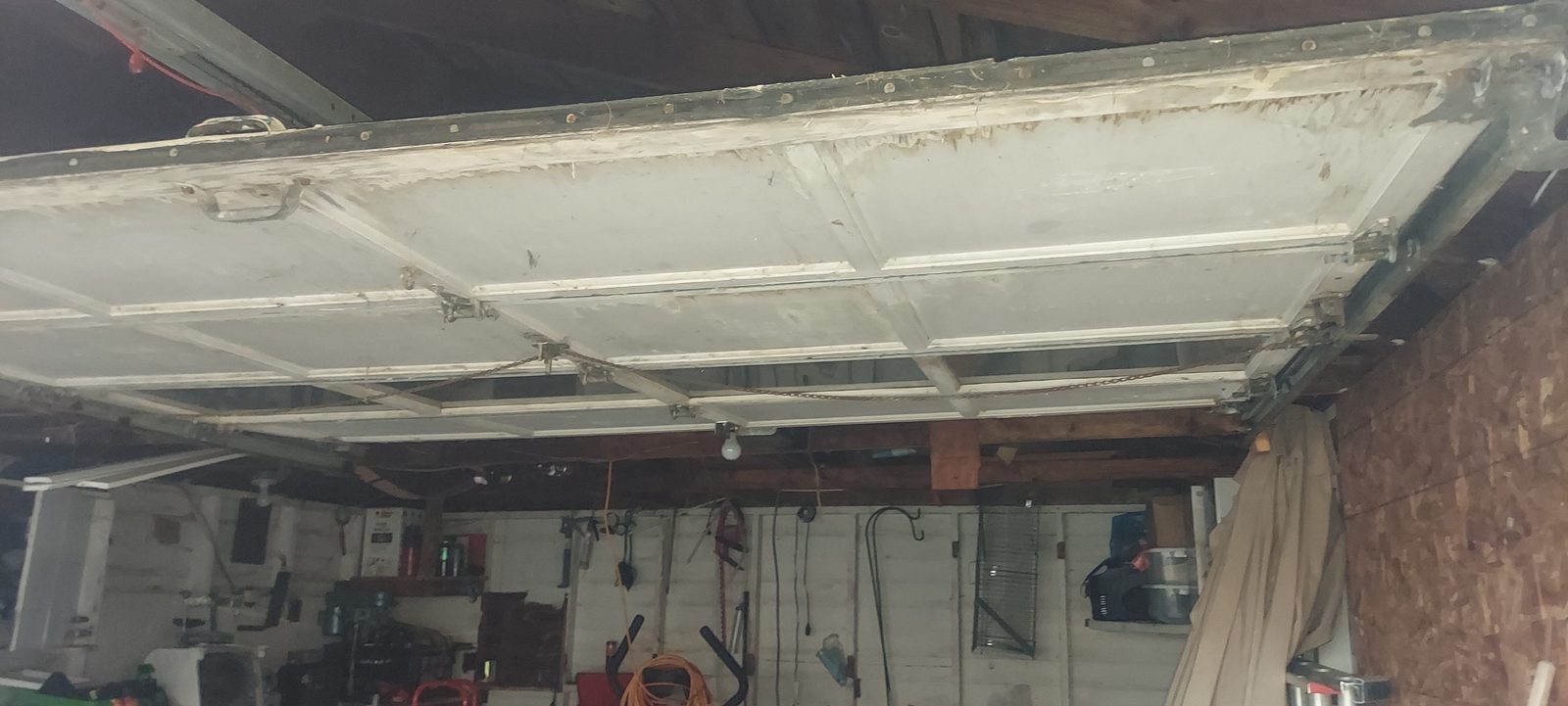Damaged garage door before repair, photo 5