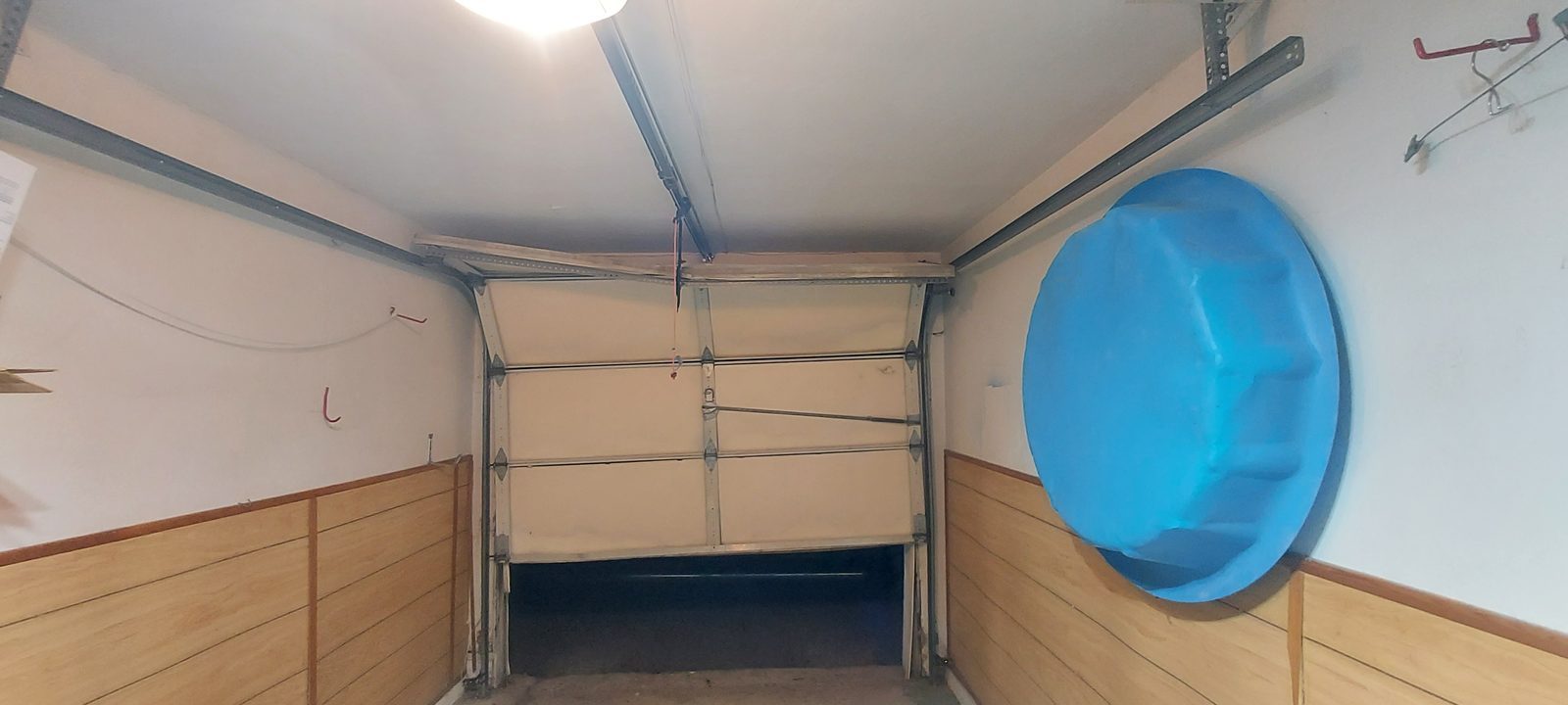 Damaged garage door before repair, photo 3