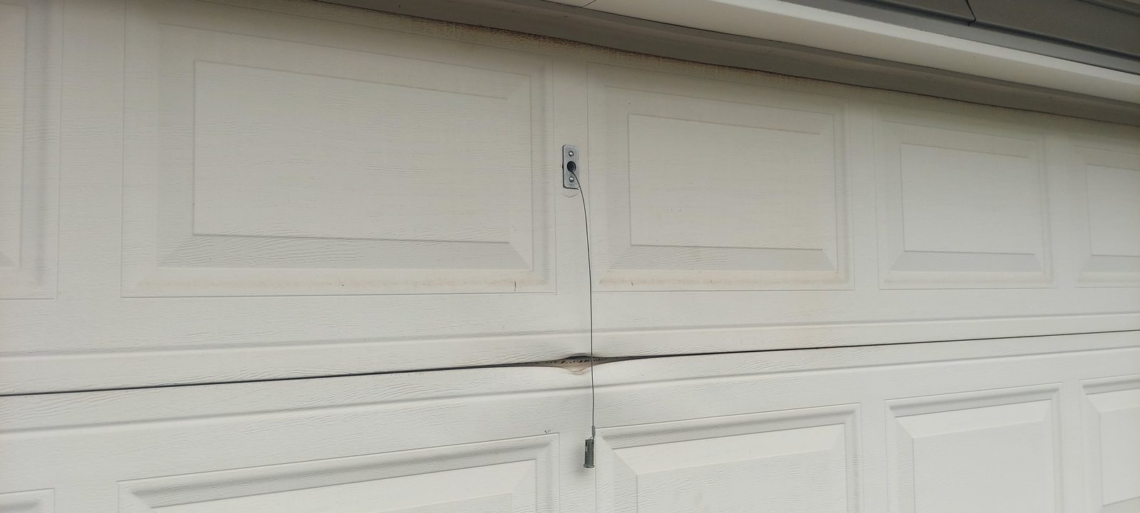 Damaged garage door before repair, photo 3
