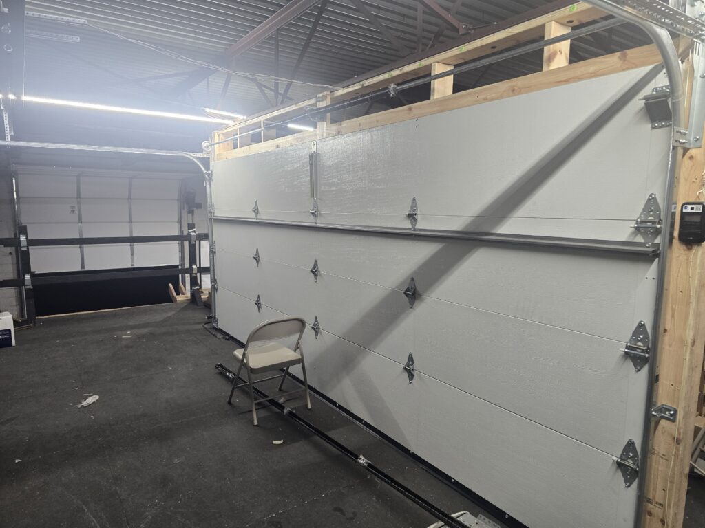 A garage door set up inside the Proactive Garage Door Repair shop in Brunswick, Ohio