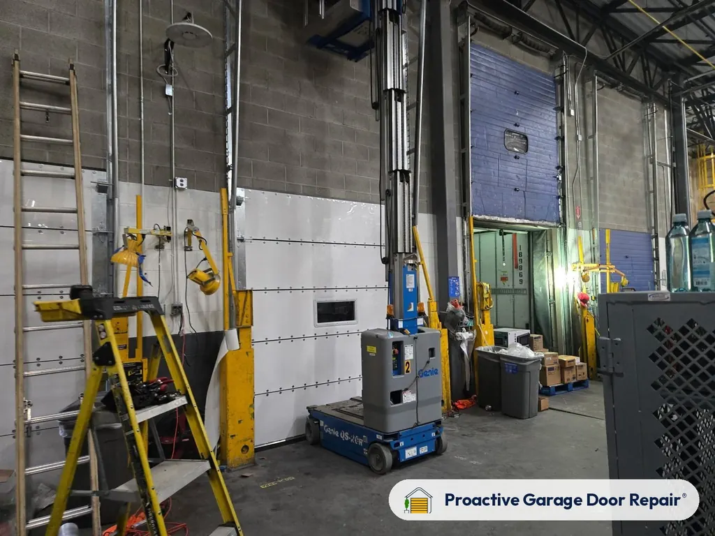 Commercial overhead doors in a warehouse serviced by Proactive Garage Door Repair
