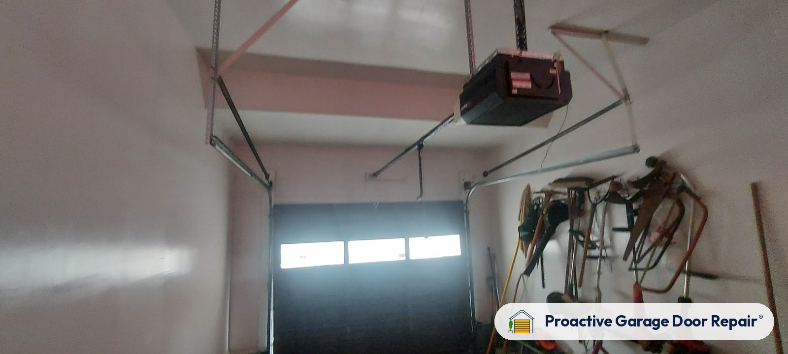 Garage door opener and rail in a customer garage, Proactive Garage Door Repair job
