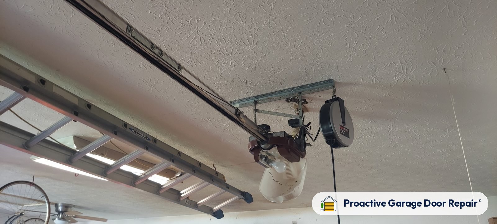 Garage door opener and rail in a customer garage, Proactive Garage Door Repair job