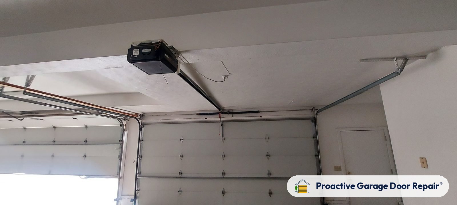 Garage door opener and rail in a customer garage, Proactive Garage Door Repair job