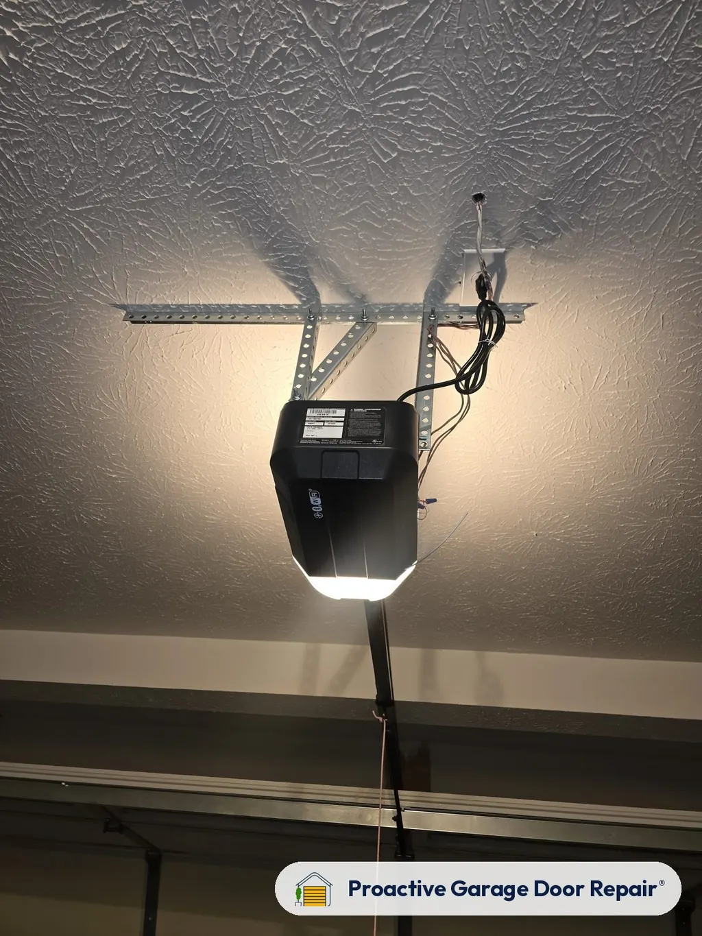 Garage door opener with its light on in a garage