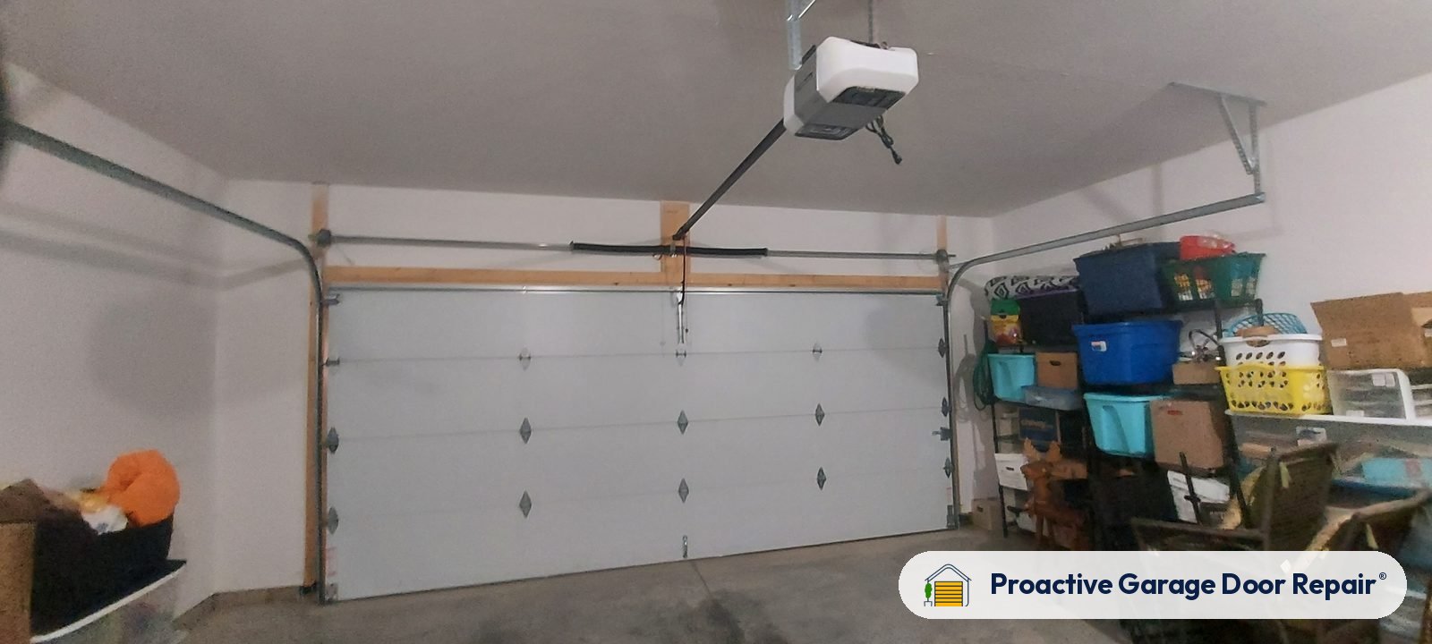 Garage door opener mounted on the ceiling of a home garage