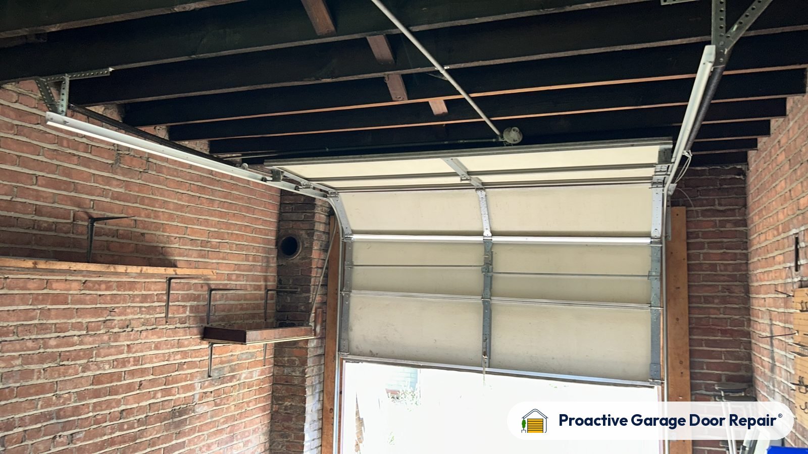 Garage door partly open in a brick garage