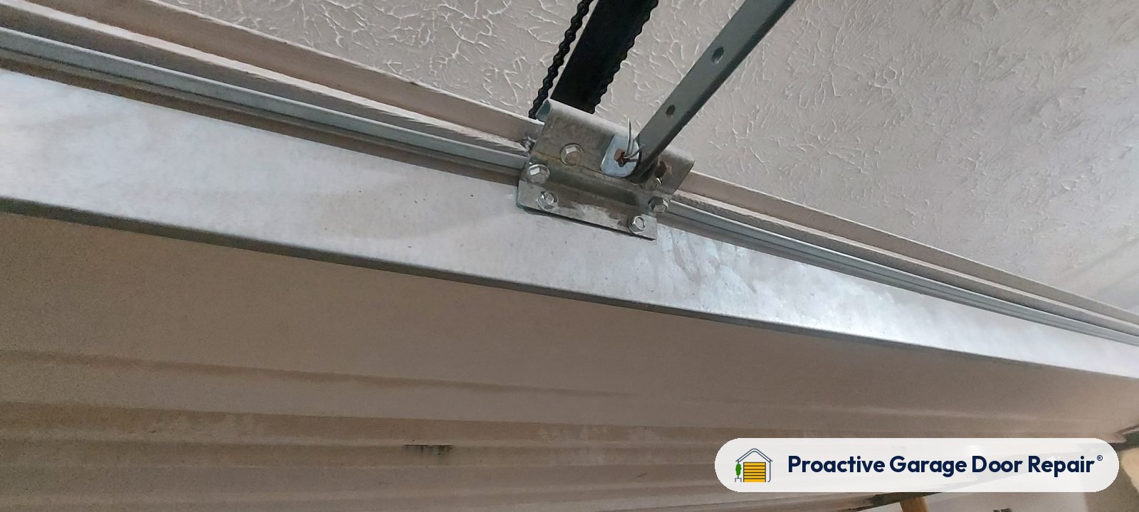 Close-up of a garage door track and rail bracket