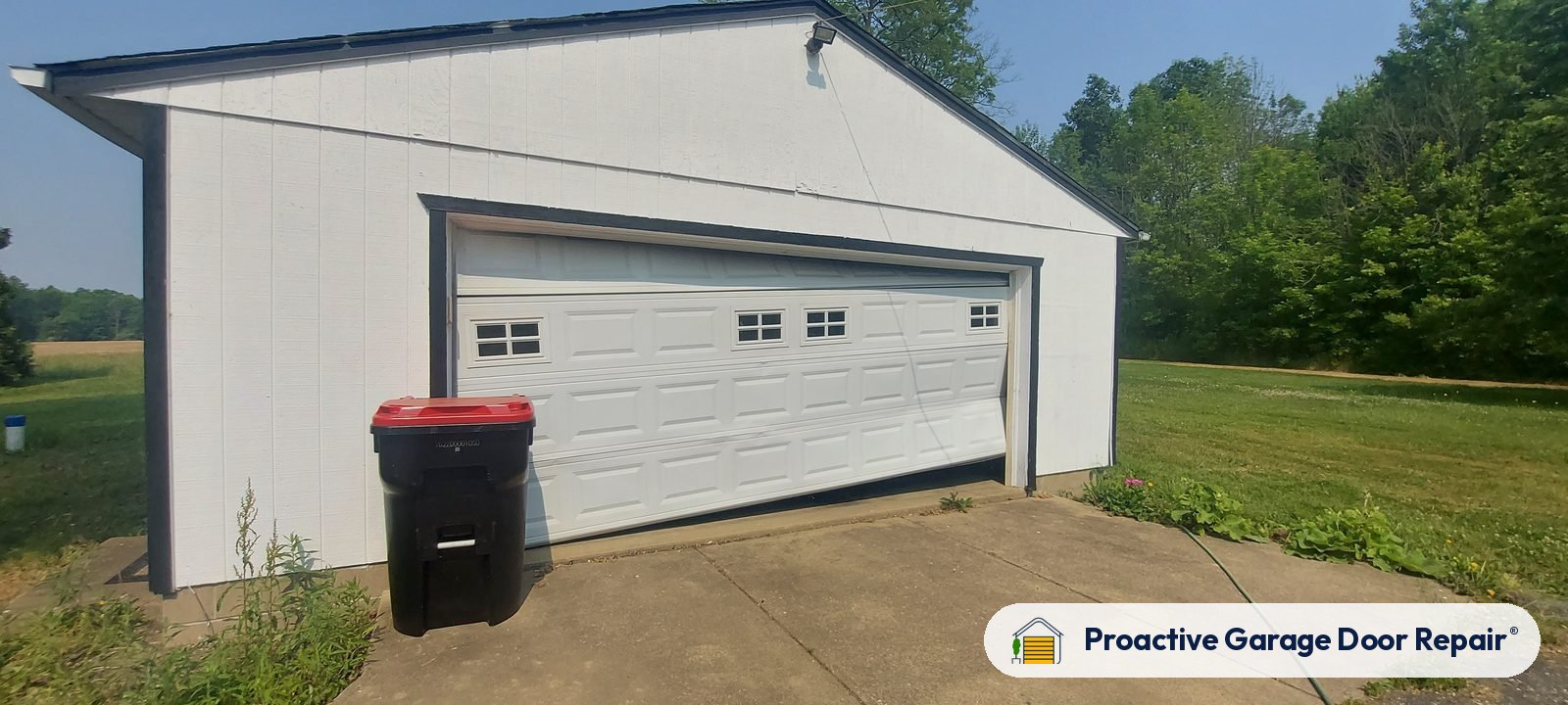 White double garage door with windows on a detached garage
