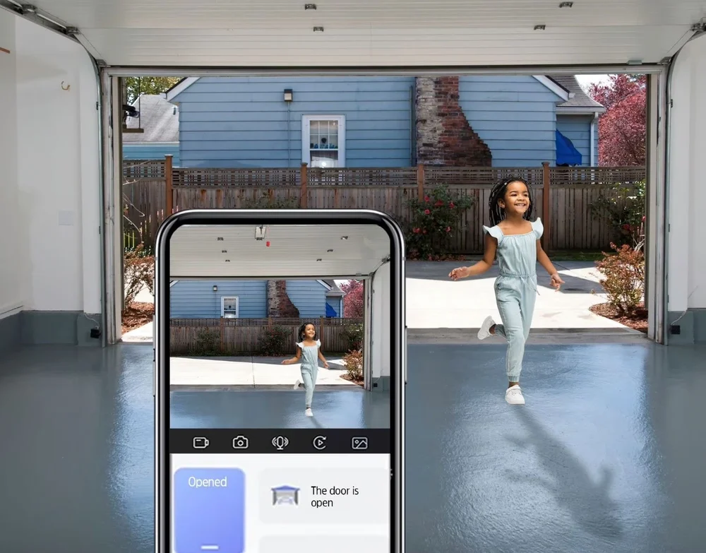 Smart opener app showing a live camera view of the open garage door and driveway